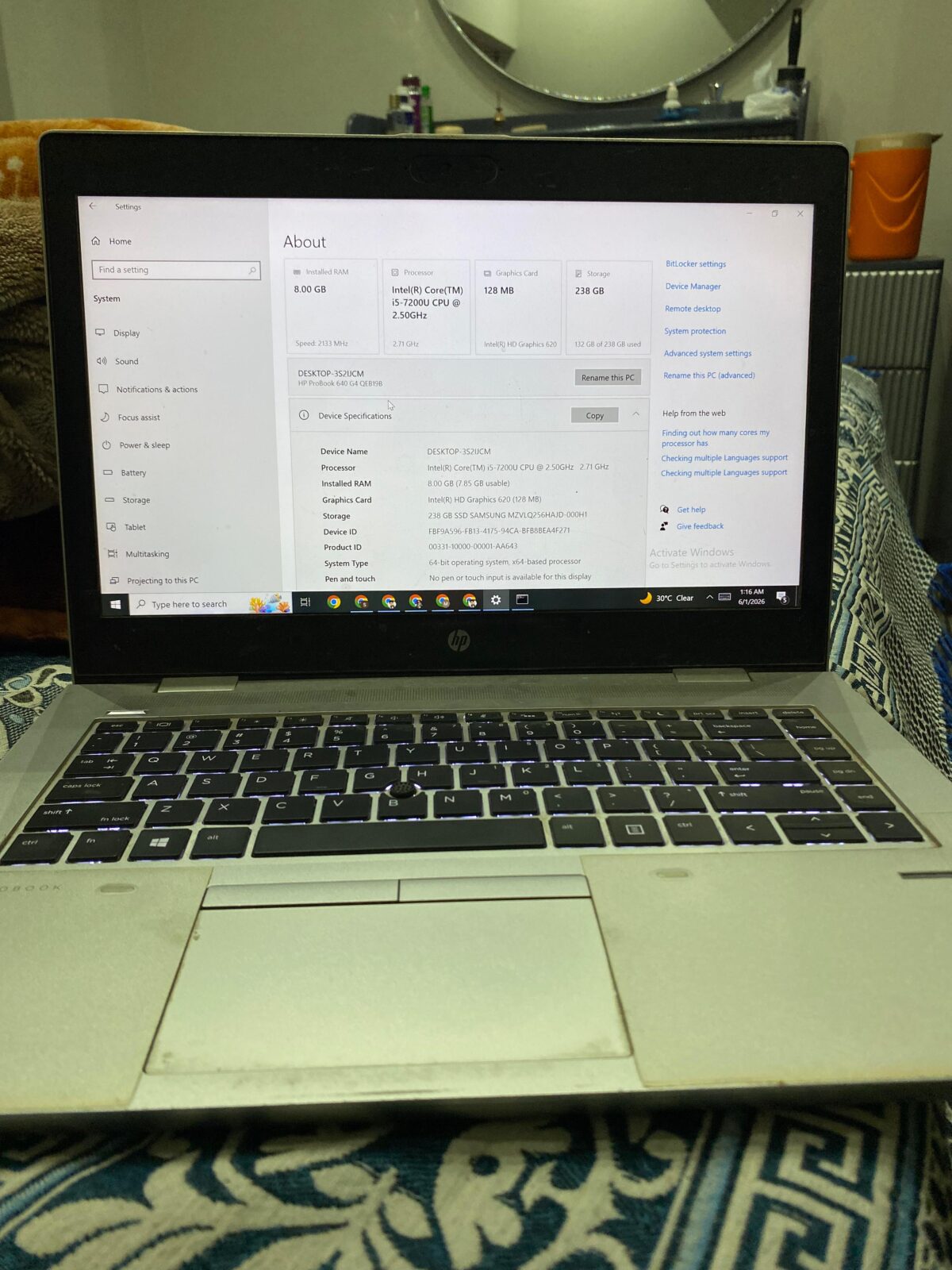 HP ProBook 640 G4 resting alongside its bundled stock charger, laptop transit case, and pre-applied screen protector layer.