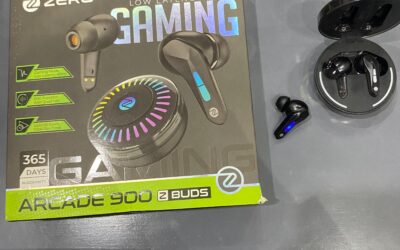 Zero-Lifestyle-Arcade-900-Z-Buds-retail-box-next-to-the-open-circular-charging-case-and-a-black-gaming-earbud-on-a-desk